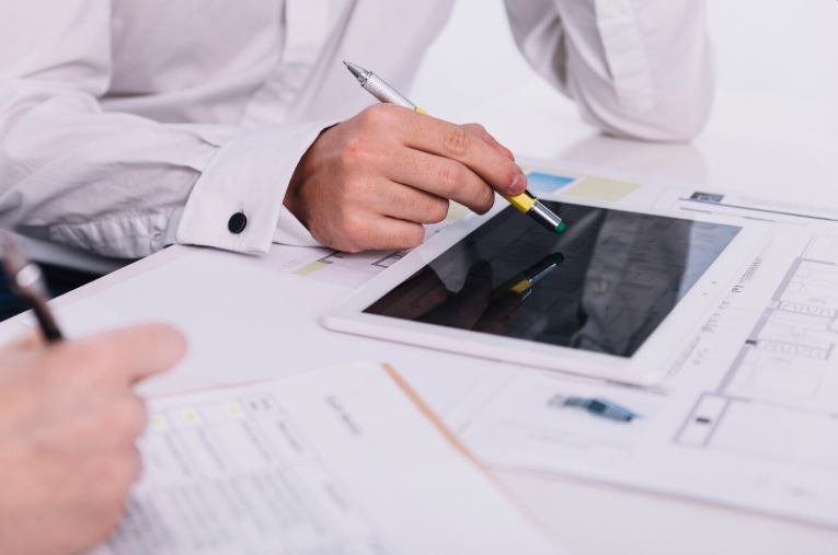 Elementor custom development - Person using tablet with documents